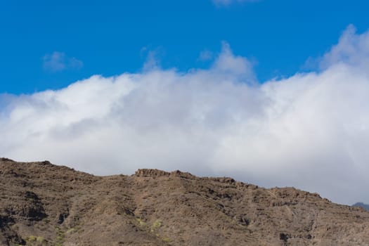 Mountains on the coast between Puerto de Mogan and Puerto Rico. Layers of volcanic rock.
