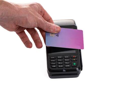 Attached plastic card to the payment terminal with a man's hand on a white isolated background, copy space. High quality photo