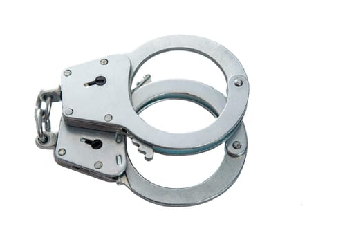 Metal handcuffs on a white isolated background, copy space. High quality photo