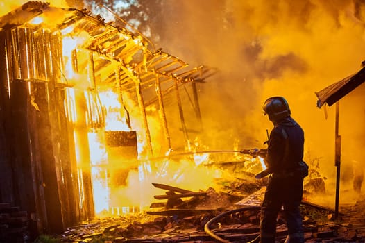 Firefighters extinguish a fire in a farm building. High quality photo
