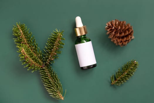 Green Pipette Dropper Bottles with blank label between fir branches and pine cones top view. Brand packaging mockup. Skincare beauty product, cream or serum. Natural cosmetics concept