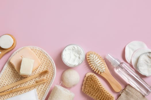 Organic natural cosmetics and zero waste reusable accessories for skin and hair care on pink flat lay with copy space. Top view of eco friendly beauty products for bath, massage or spa salon