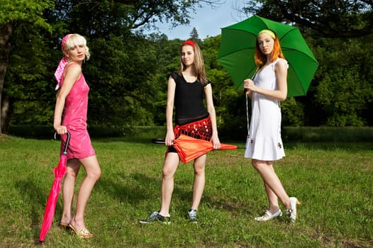 3 women with umbrella