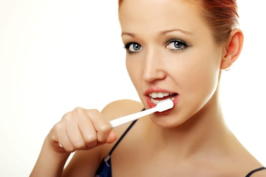 Young woman brushes her teeth