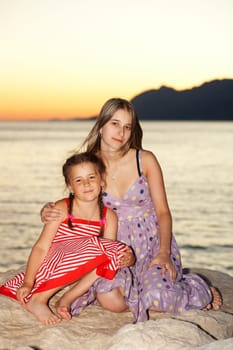 Two girls at the sea in the evening