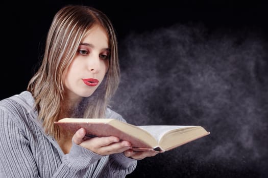 Woman blows dust away from the book I.
