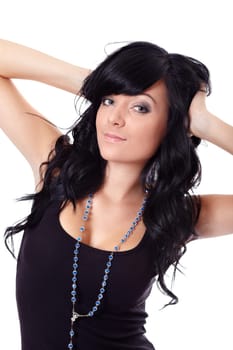 Black-haired woman with hands in hair