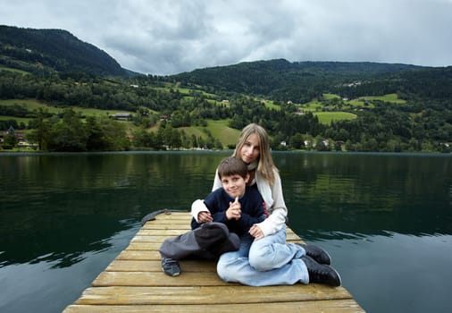 Siblings at the field by the lake