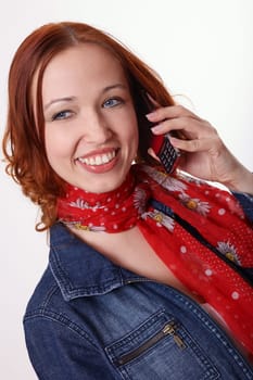 Red-haired woman makes calls from mobile phone