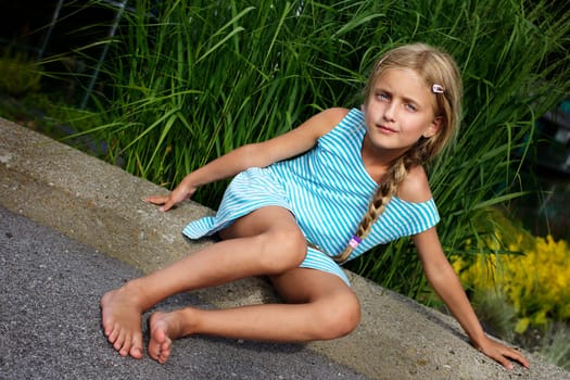 Beautiful girl relaxing on the rock IV