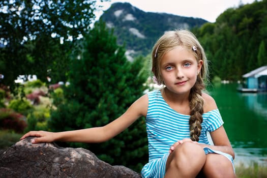 Beautiful girl relaxing on the rock II