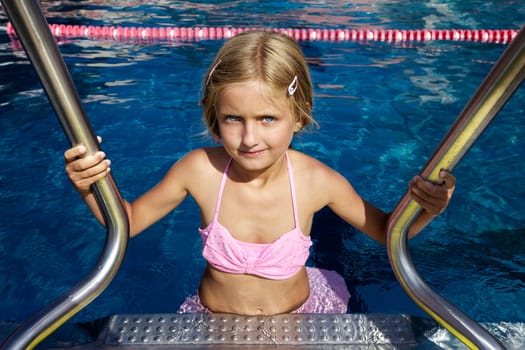 Blond girl swimming in pool II