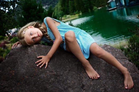 Beautiful girl relaxing on the rock III