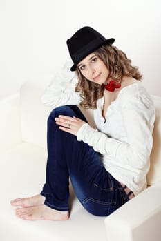 Portrait of a young woman sitting on a sofa