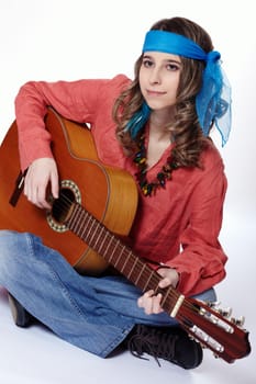 Young hippie woman playing the guitar
