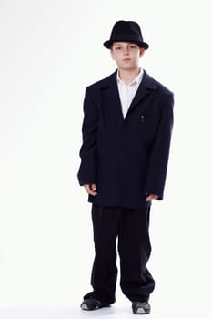 Young staying boy wearing a suit