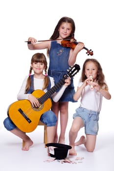 Three girls playing the musical instruments
