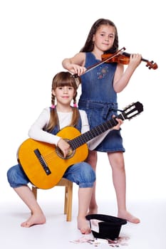 Two girls playing the musical instruments