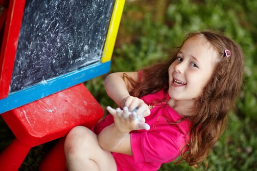 A girl preparing to draw on a board