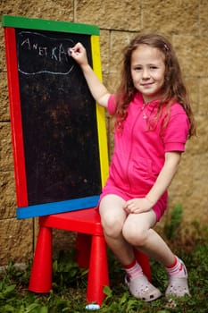 A girl writing on a board