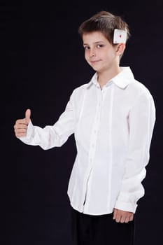 Portrait of a young boy with an ace