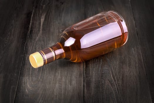 The Bottle of whiskey on a wooden background