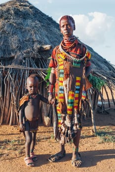 Turmi, Omo River Valley, Ethiopia - May 10, 2019: Portrait of a beautiful woman with children in Hamar village. Hamars are the original tribe in southwestern Ethiopia. South Ethiopia Africa