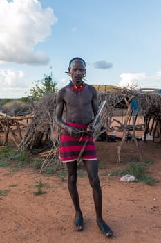 Turmi, Omo River Valley, Ethiopia - May 10, 2019: Portrait of a Hamar man in Hamar village. Hamars are the original tribe in southwestern Ethiopia.