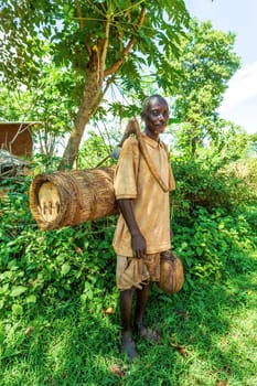 Southern Nations, Ethiopia - May 10, 2019: Unknown poor Ethiopian farmer with a bee hive and an primitive ax on his back in May 10. 2019 in Southern Nations , Ethiopia