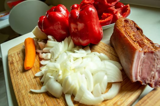 Lots of chopped onion, red pepper and bacon, close up