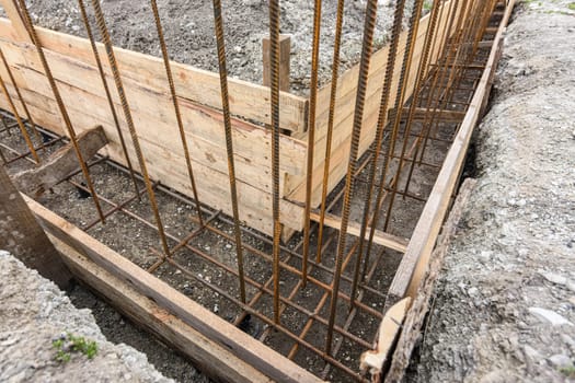 The angle of the strip foundation in preparation for concreting and reinforcement during the construction of a house