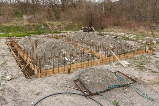 The general plan for the construction of a one-story private house, a trench has been dug, formwork and reinforcement are being installed