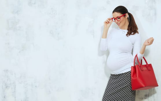 Fashion portrait of pregnant businesswoman - pregnant woman in business casual.
