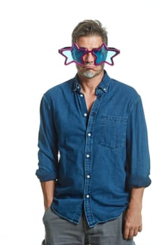 Sad older man in funny party glasses isolated on white background.