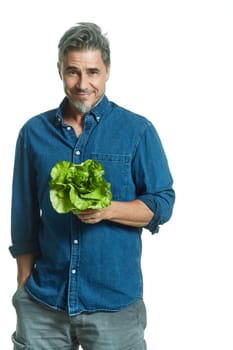 Casual older white man man holding green salad - healthy eating.
