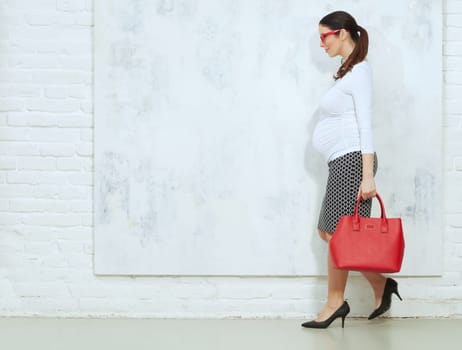 Fashion portrait of pregnant businesswoman - pregnant woman in business casual.