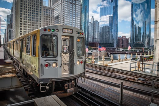 Chicago, Illinois, United States of America : October 11, 2018, Train on elevated tracks within buildings at the Loop, Glass and Steel bridge between buildings - Chicago City Center - Chicago, Illinois, USA
