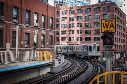 Chicago : October 11, 2018, Train on elevated tracks within buildings at the Loop, Glass and Steel bridge between buildings - Chicago City Center - Chicago, Illinois, USA