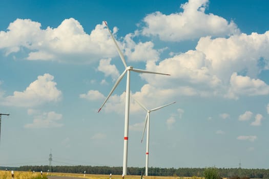 Sustainable green energy. Electric windmill generators in the sunrise