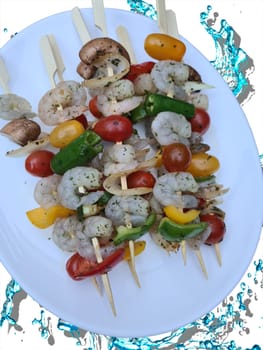 Grilled shrimp skewers. Seafood, shelfish. Shrimps Prawns skewers with herbs, garlic and lemon on black stone background, copy space. Shrimps prawns brochette kebab. Barbecue srimps prawns.