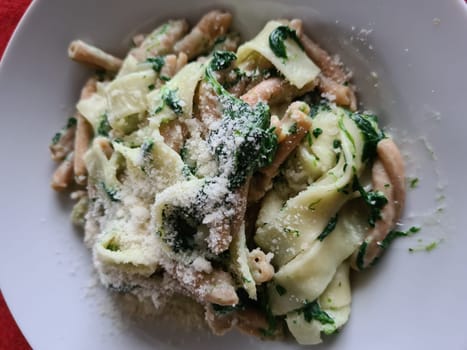 Pasta bolognese. Traditional italian dish of pasta with tomato and meat mince sauce served in a plate with parmesan cheese and thyme, top view