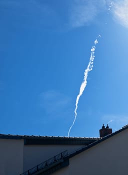 vapor trials, unusually and interesting shaped, vanishing, curling, ascending over roof tops in the sky, looking like white chimney smoke, symbolic