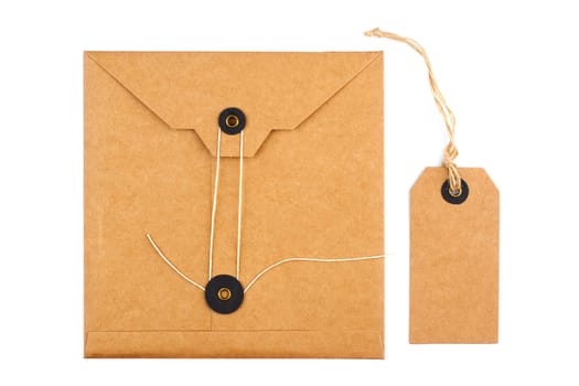top view closeup gift set of craft paper tag and envelope with textile thread mockup isolated on white background