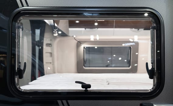 outside view of camp caravan RV window with bedroom inside