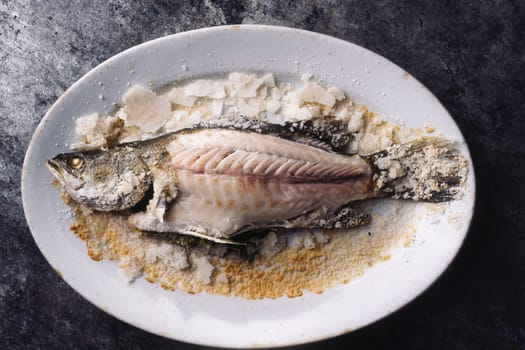 close up of sicilian italiansalt baked seabass fish