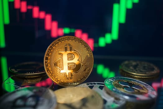 Bitcoin and cryptocurrency investing concept. Cryptocurrency golden coin with gold ripple symbol. Rise and fall charts of alt coins.