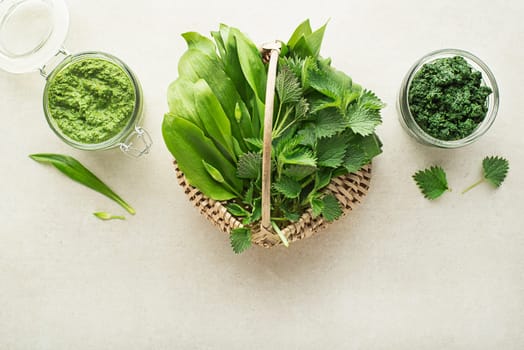 Spring healthy food. Nettle and ramson pesto for healthy meal on grey background