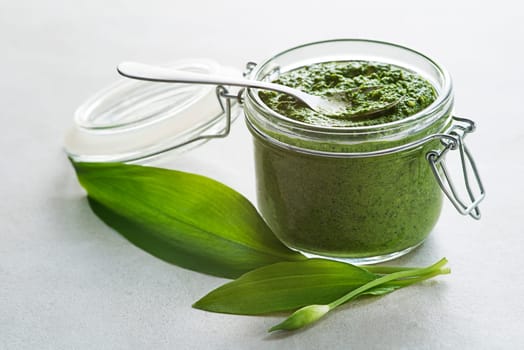 Fresh ramson or wild garlic pesto close up. Healthy spring food concept
