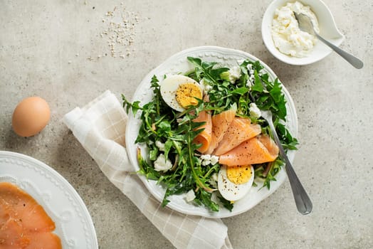 Dandelion salad with smoked salmon, egg and fresh cheese