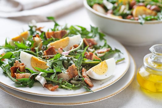 Dandelion salad with eggs and bacon close up